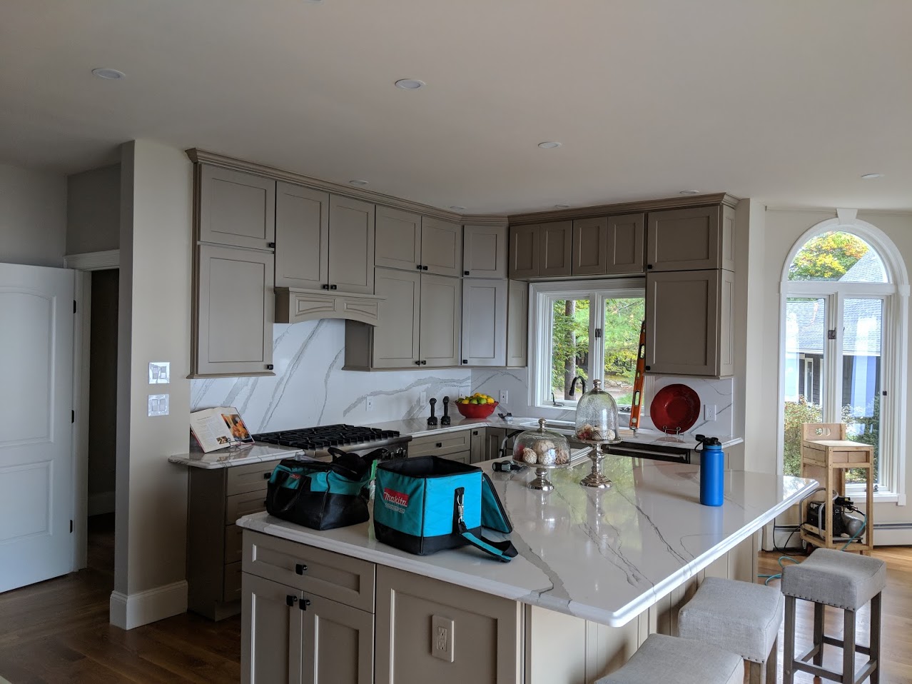 A kitchen with gray cabinetry.