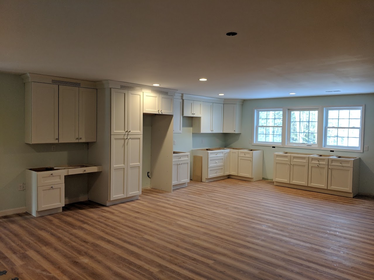 An open-floor kitchen with white cabinetry.